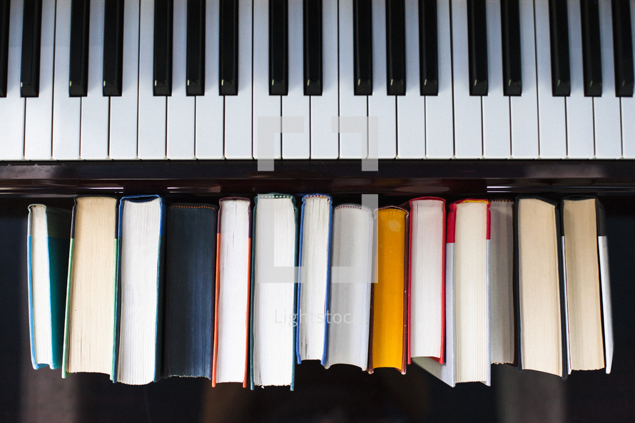 piano keys and a row of books 