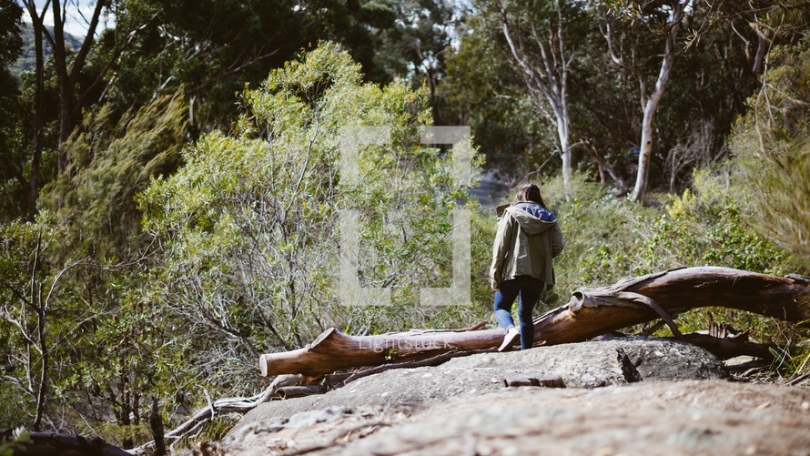 a woman hiking in a forest 