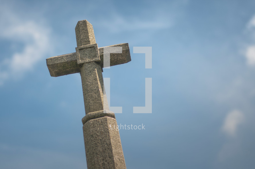 stone cross against a blue sky