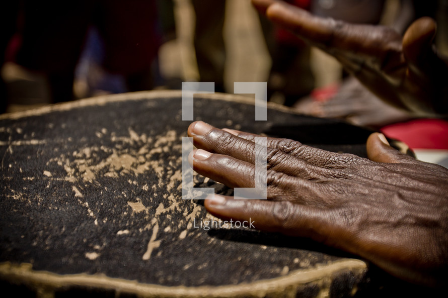  Black hands playing on a drum - music