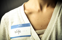 woman wearing a name tag with the word wife