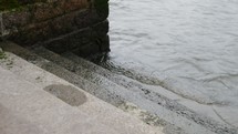 water lapping onto concrete steps 