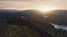 Cross on a hill at sunrise 