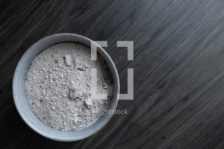 bowl of ashes on a wood background 