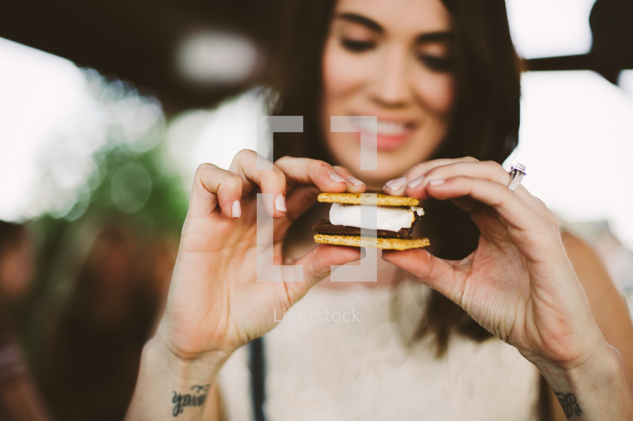 a woman eating a s'more 