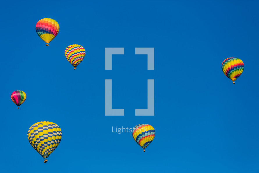 Hot air balloons in a blue sky.