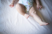an infant's chubby legs 