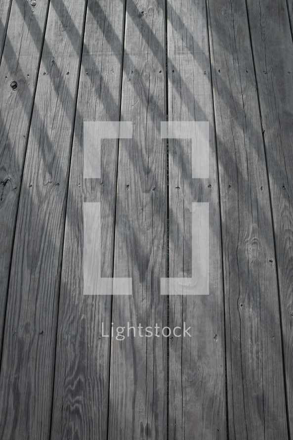 shadows on a wood deck 