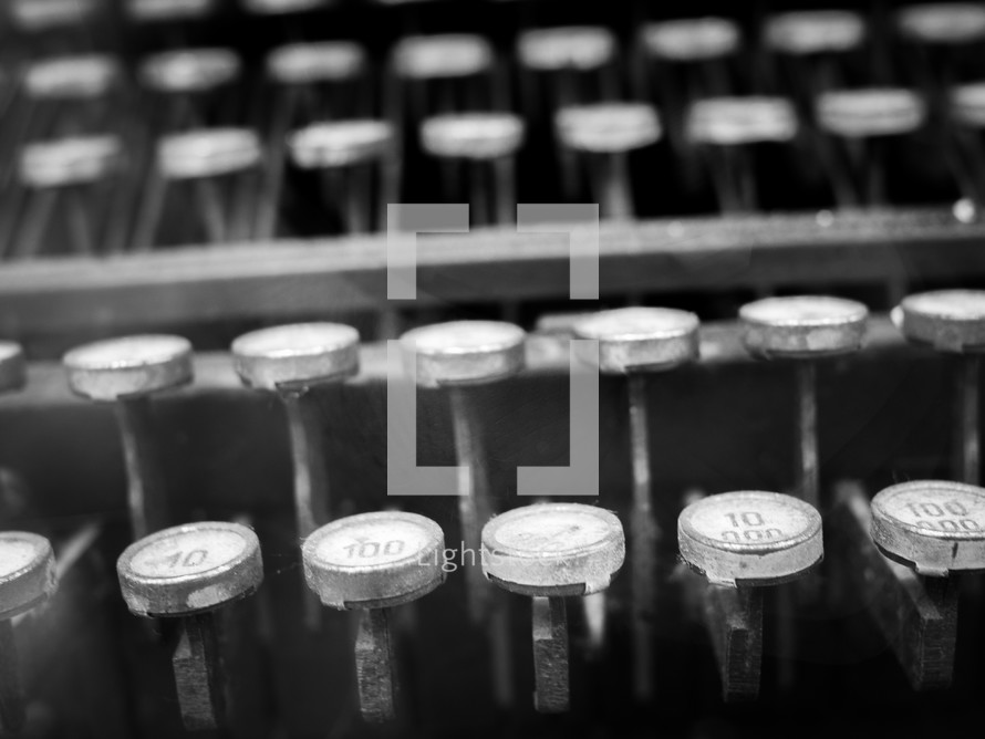 a black and white shot of old typewriter keys