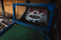 Old, mini golf game with graffiti on face