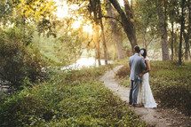bride and groom standing on an outdoor path