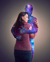 a woman hugging a space silhouette man