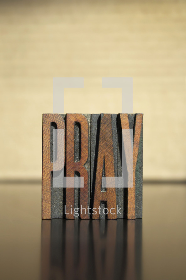 word Pray in wood blocks 