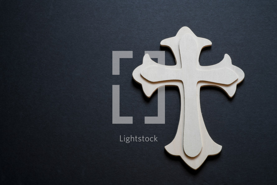 wooden cross on a black background 
