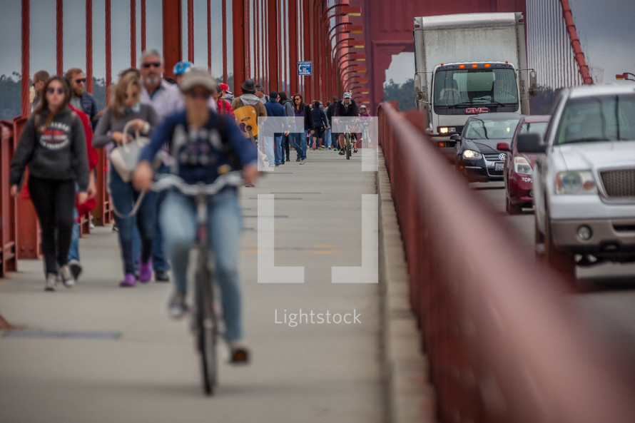 pedestrians and bicyclists on a bridge 