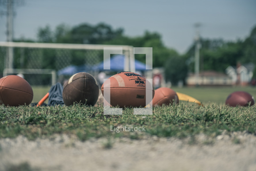 footballs on a practice field 