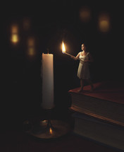 tiny woman lighting a candle 
