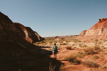 a woman hiking on a desert landscape 