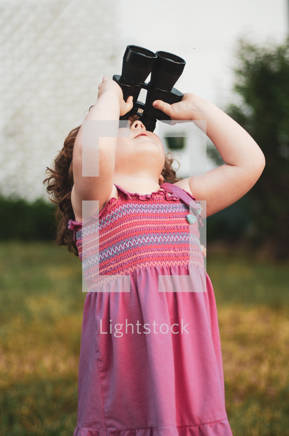 a girl looking through binoculars 