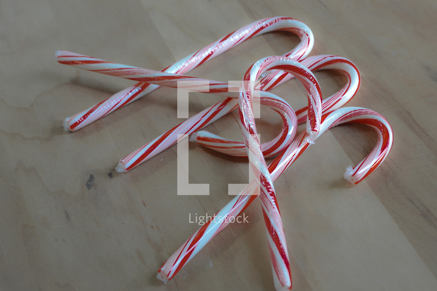 candy canes on a wood background 