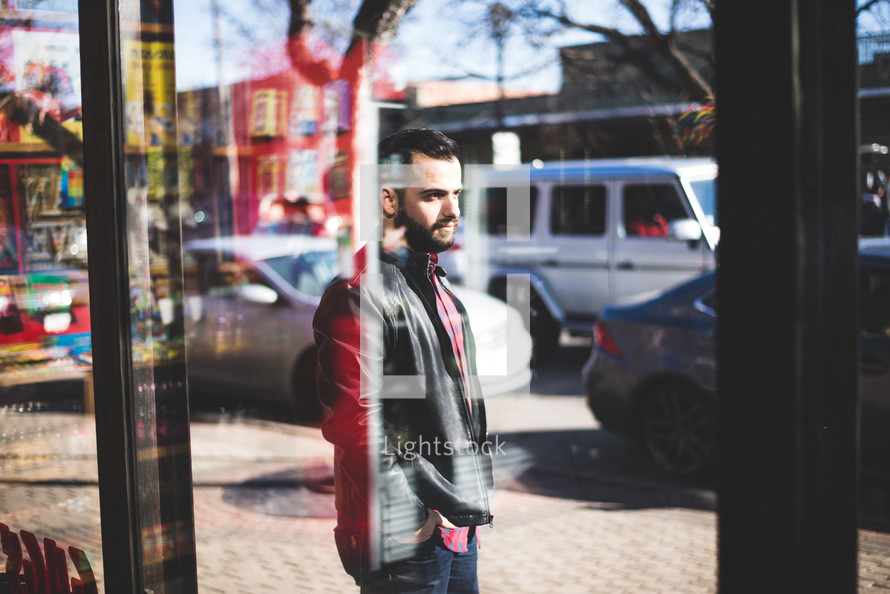 a man walking in front of a store window 