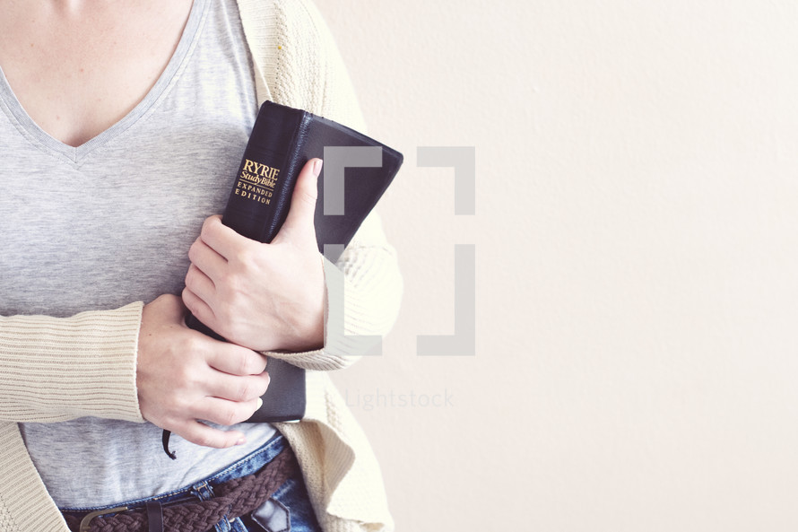 a woman holding a Bible 