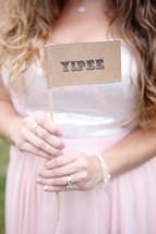 woman holding a Yipee sign 