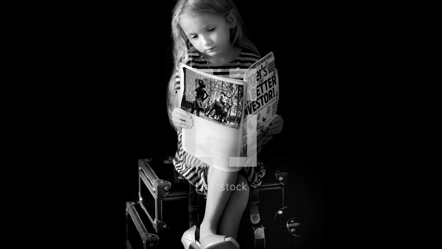 child reading a magazine 
