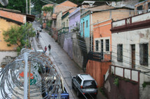 houses lining a street and barbed wire 