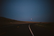 moon over a curve in the road 