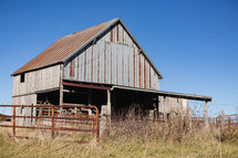 Wooden barn with metal roof in rural area