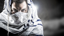 man's face covered by prayer shawl