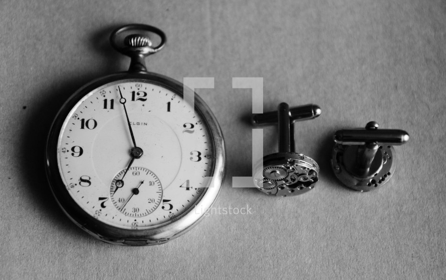 A pocket watch and cuff links.
