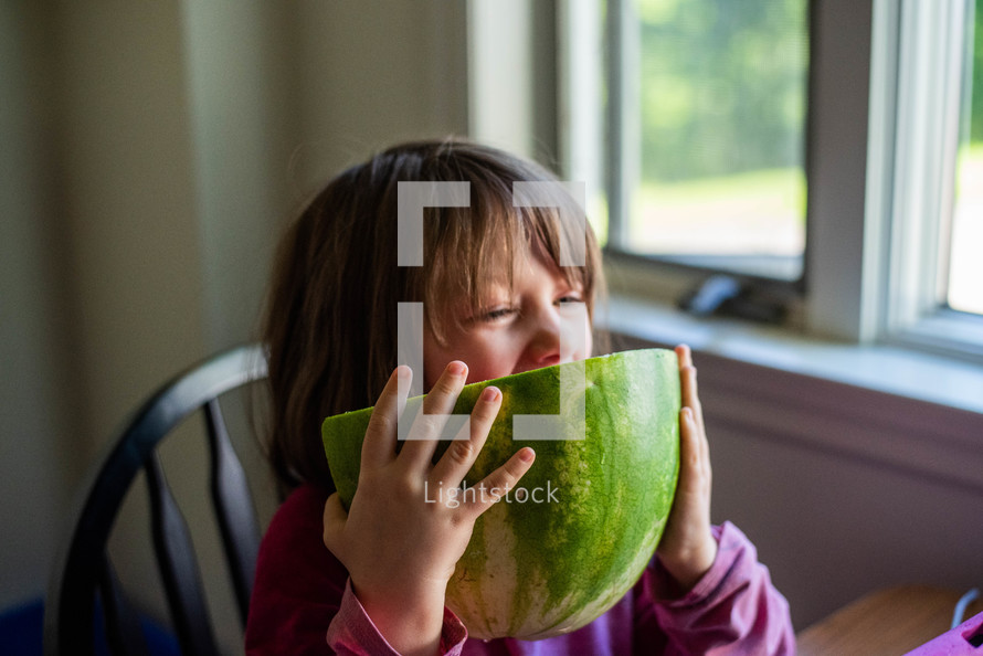 a girl eating watermelon 
