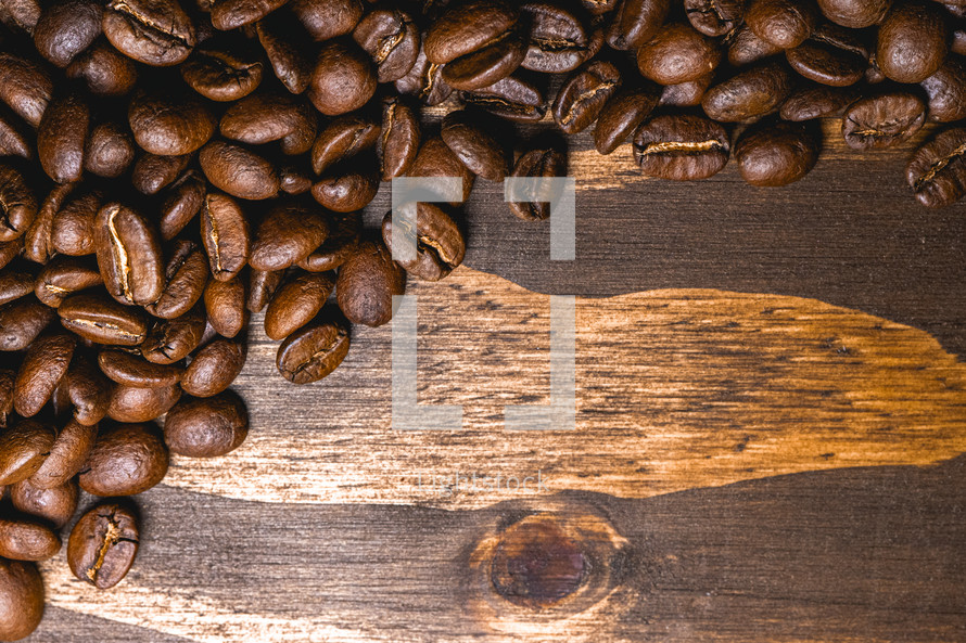 Coffee beans on a wooden background. Decorative banner for coffee products.