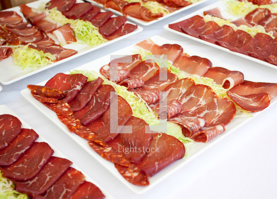 Mixed appetizers of pork meat on buffet table