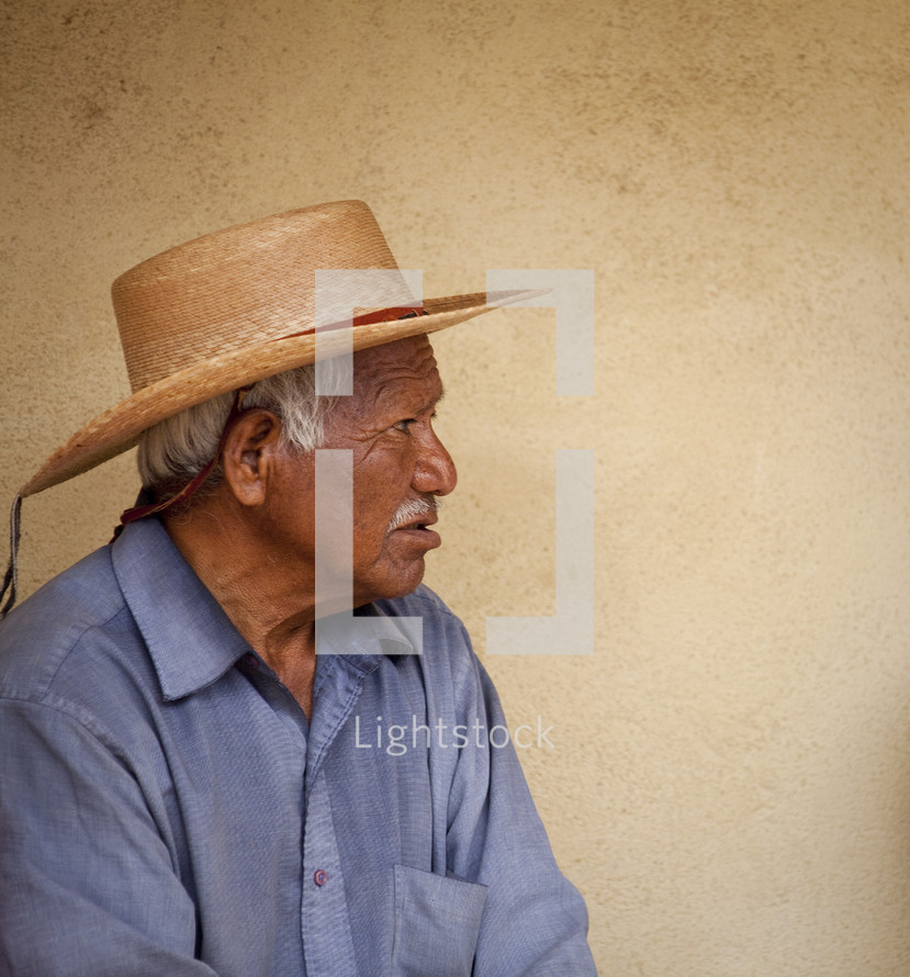 Hispanic man in a straw hat.