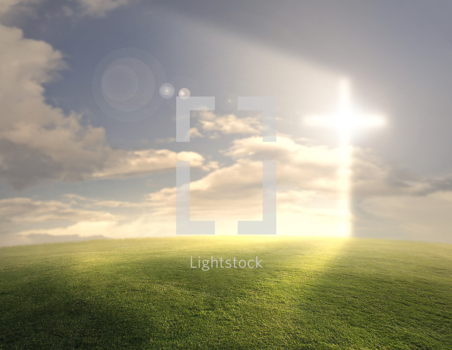 A large grassy field with a bright glowing cross on the horizon.