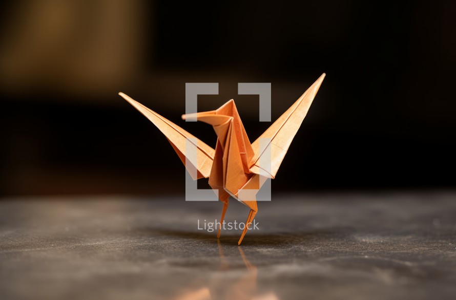 A close-up view of an origami bird resting on a table
