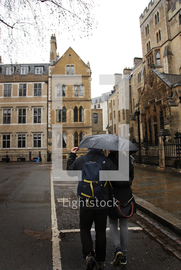 couple walking under an umbrella 