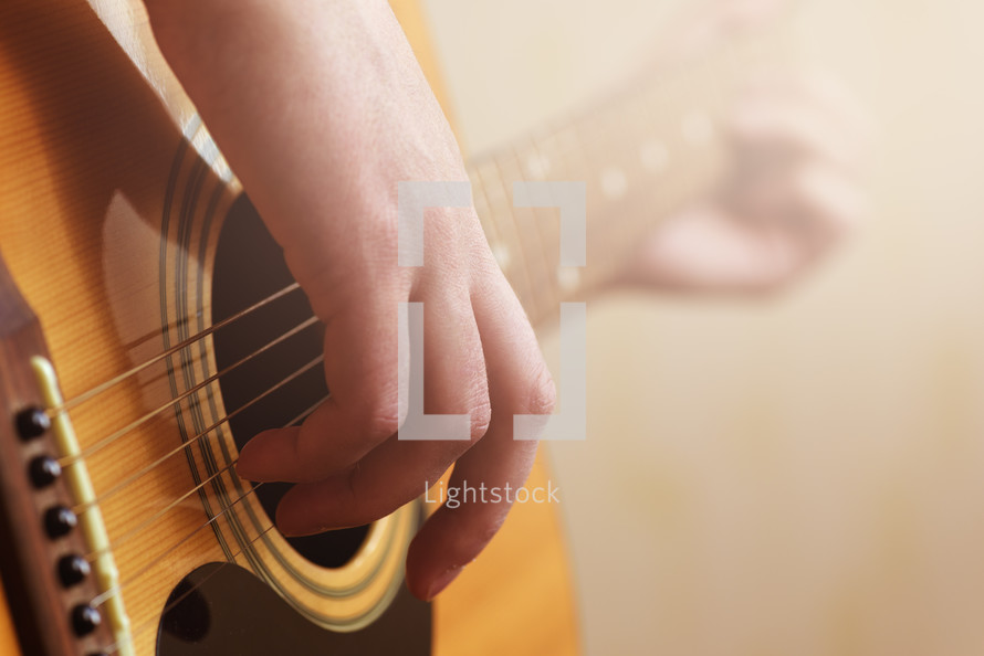 hand strumming a guitar 