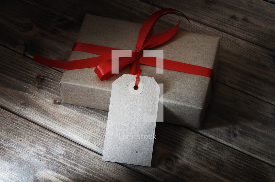 gift wrapped in brown paper and red ribbon 