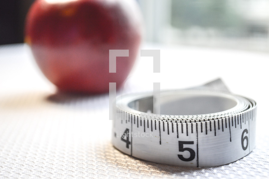 apple and measuring tape 
