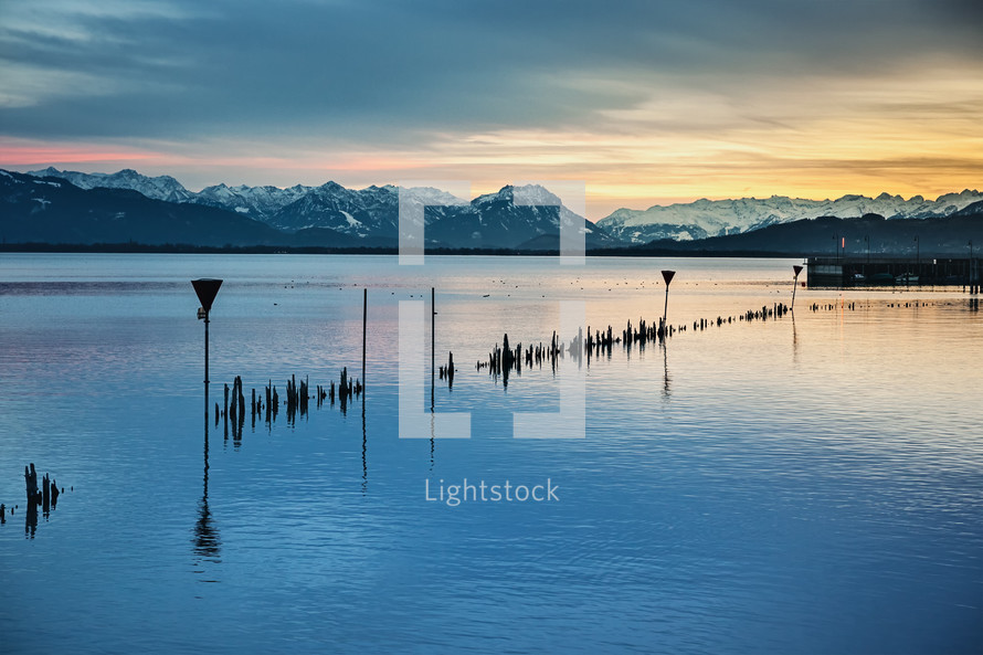 view of Swiss Alps across water at night 