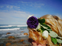 flowers in a girls hair at the ocean 