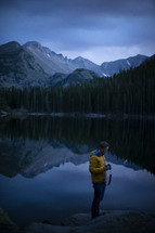 man standing near a lake in fall 