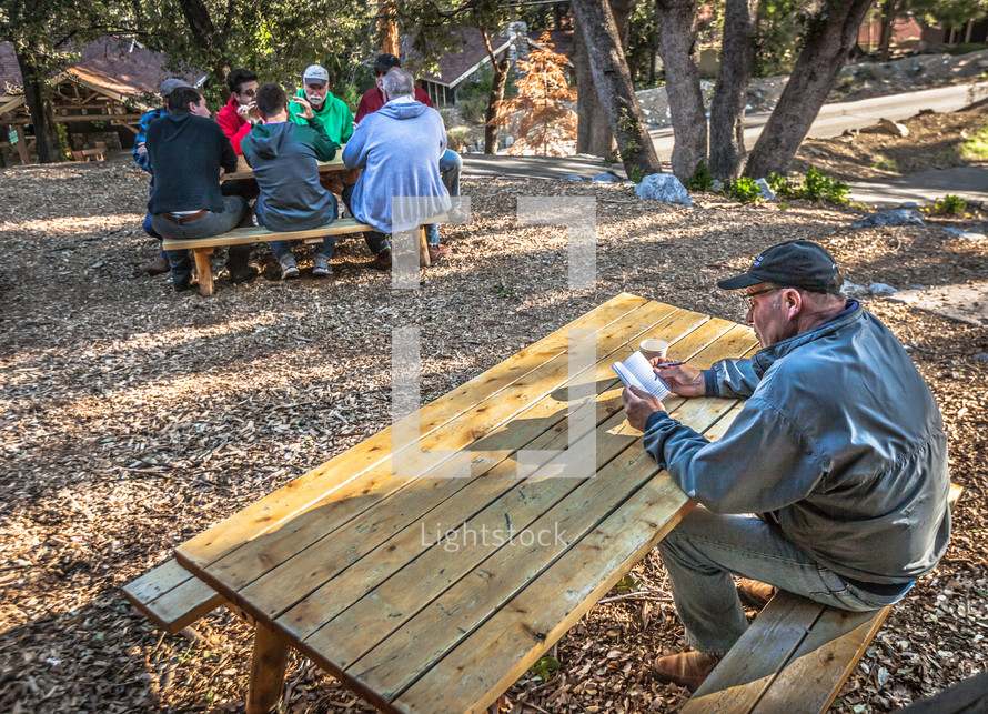 discussions at a picnic table during a men's retreat 
