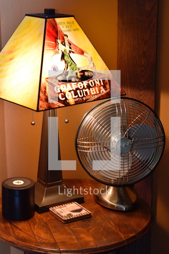side table with lamp and fan 