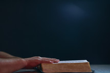 Person with hand on bible