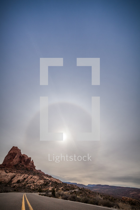sunburst over a rock peak 
